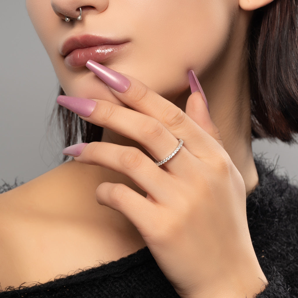 A model wearing Tennis Eternity Cubic Zirconia 925 Sterling Silver band ring on her finger.