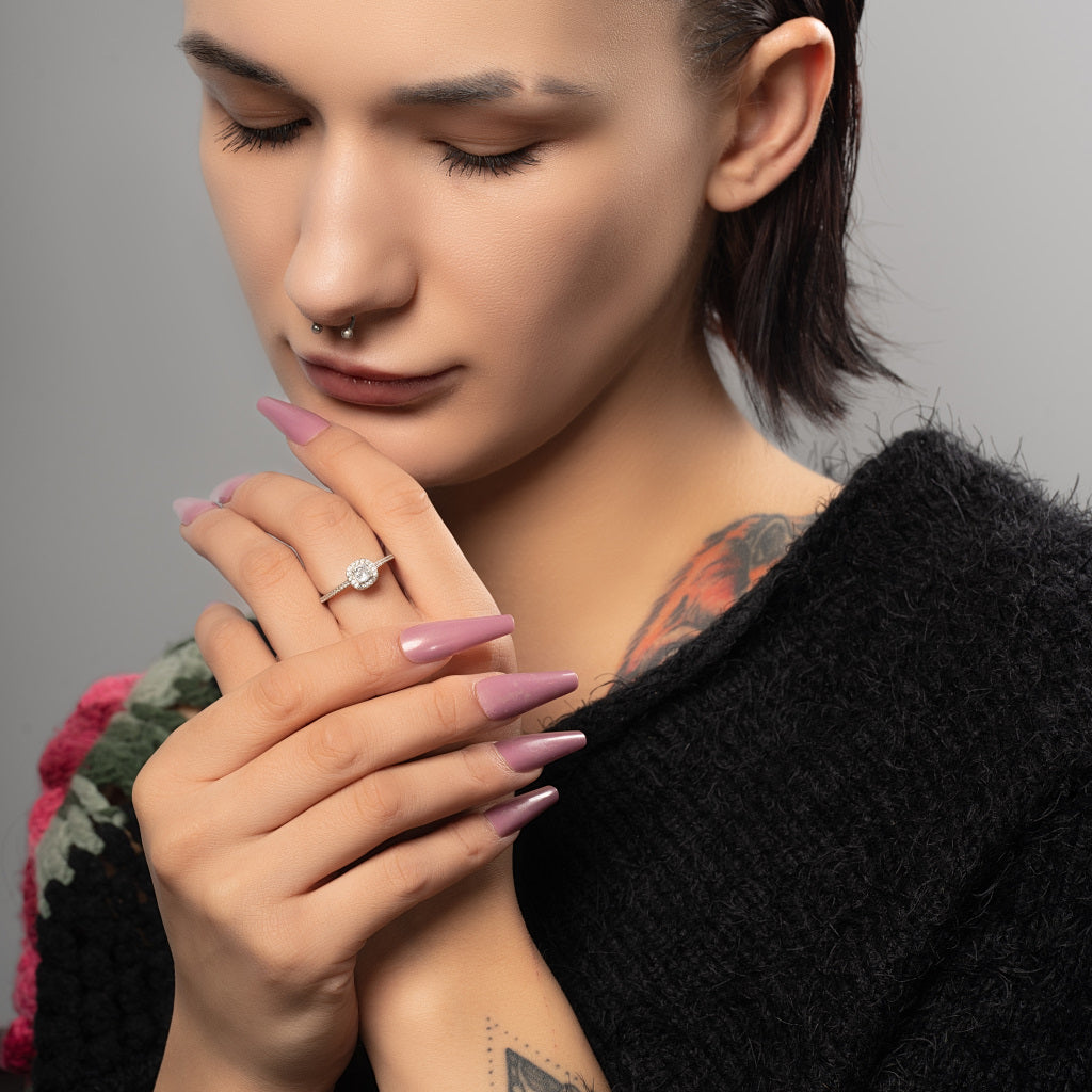 A charming female model wearing Halo Round cut Cubic Zirconia 925 Sterling Silver ring on her finger.
