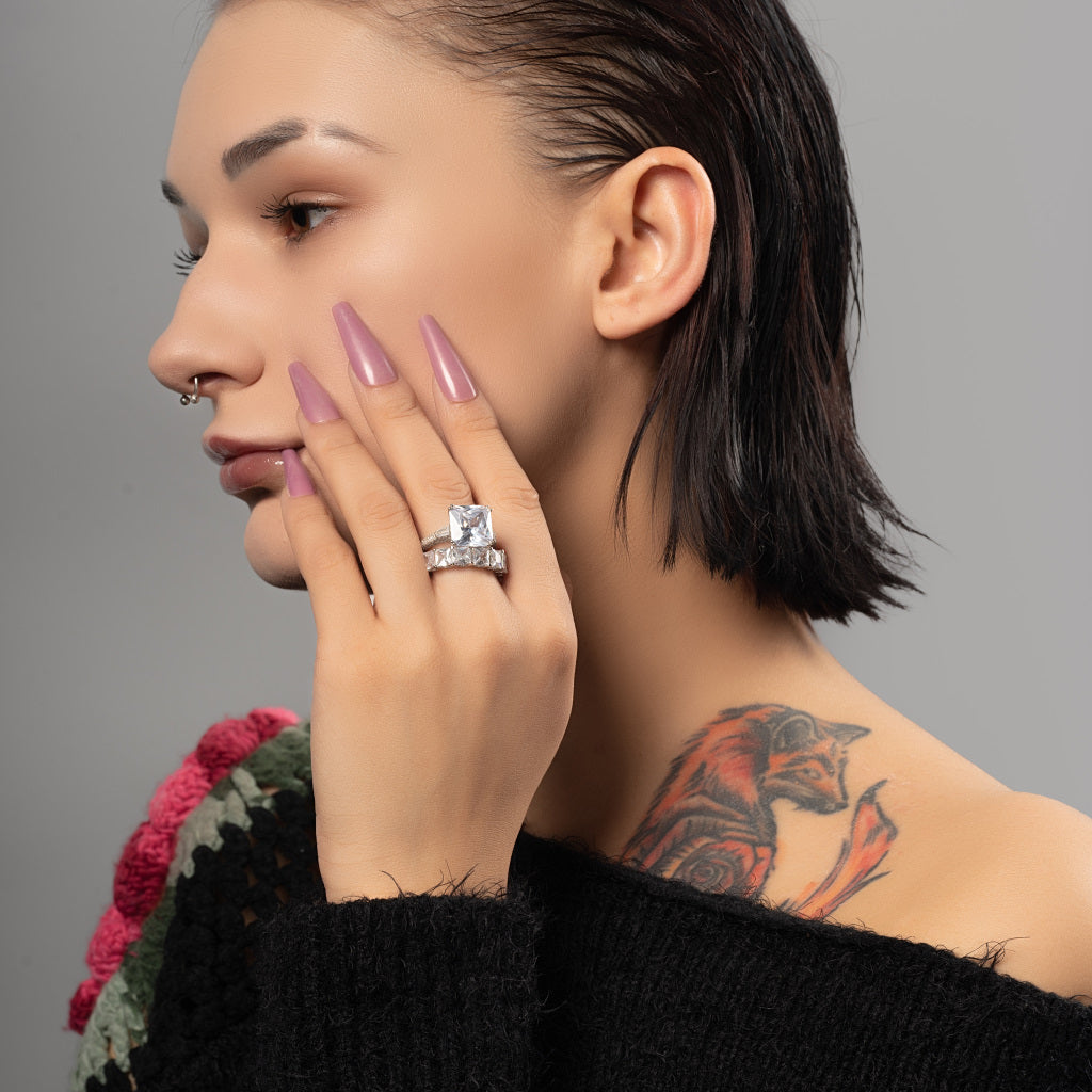 A female model wearing Asscher cut Cubic Zirconia 925 Sterling Silver stackable ring band on her finger.
