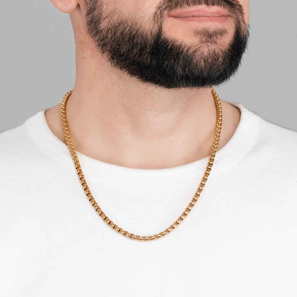 A bearded male model in white t-shirt wearing Gold Round Box Link Chain 5 mm, 22 inches, 55 cm.