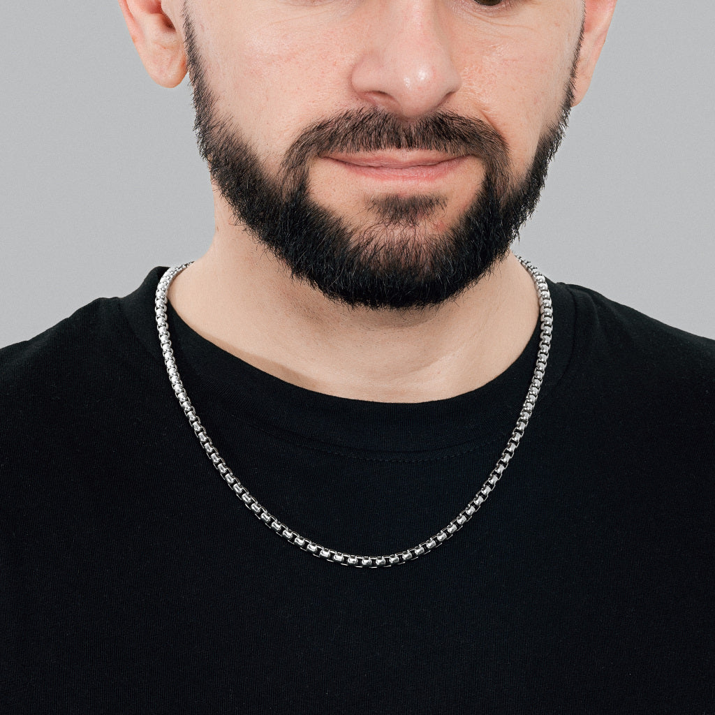A bearded male model in black t-shirt wearing Silver Round Box Link Chain 5 mm, statement, lifetime, stainless steel men's jewellery