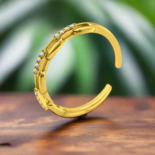 Chain CZ Gold Ring on the wooden surface with plant background