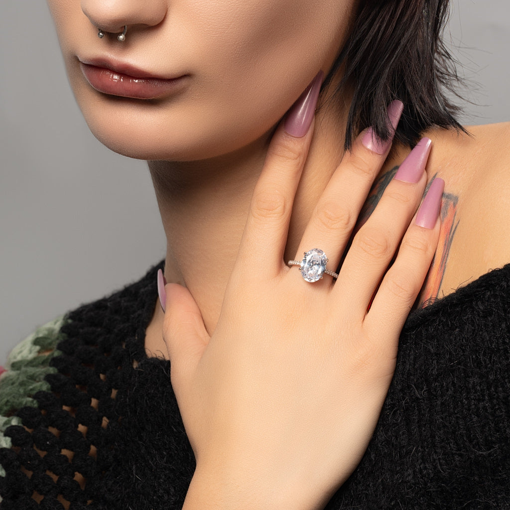 A female model wearing Oval Cut Cubic Zirconia 925 silver ring on finger