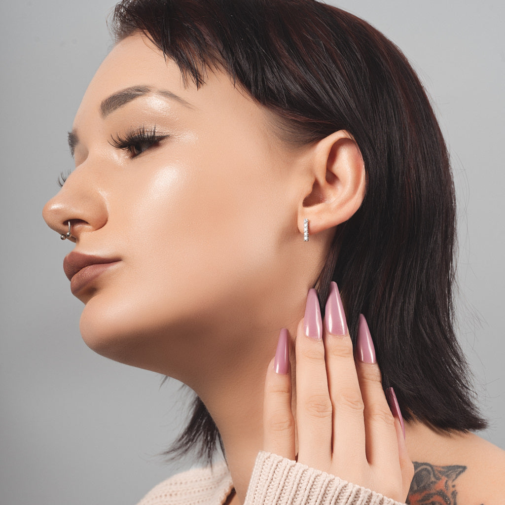 Stunning female model wearing Five CZ Line 925 Sterling Silver high quality stud earring in her ear