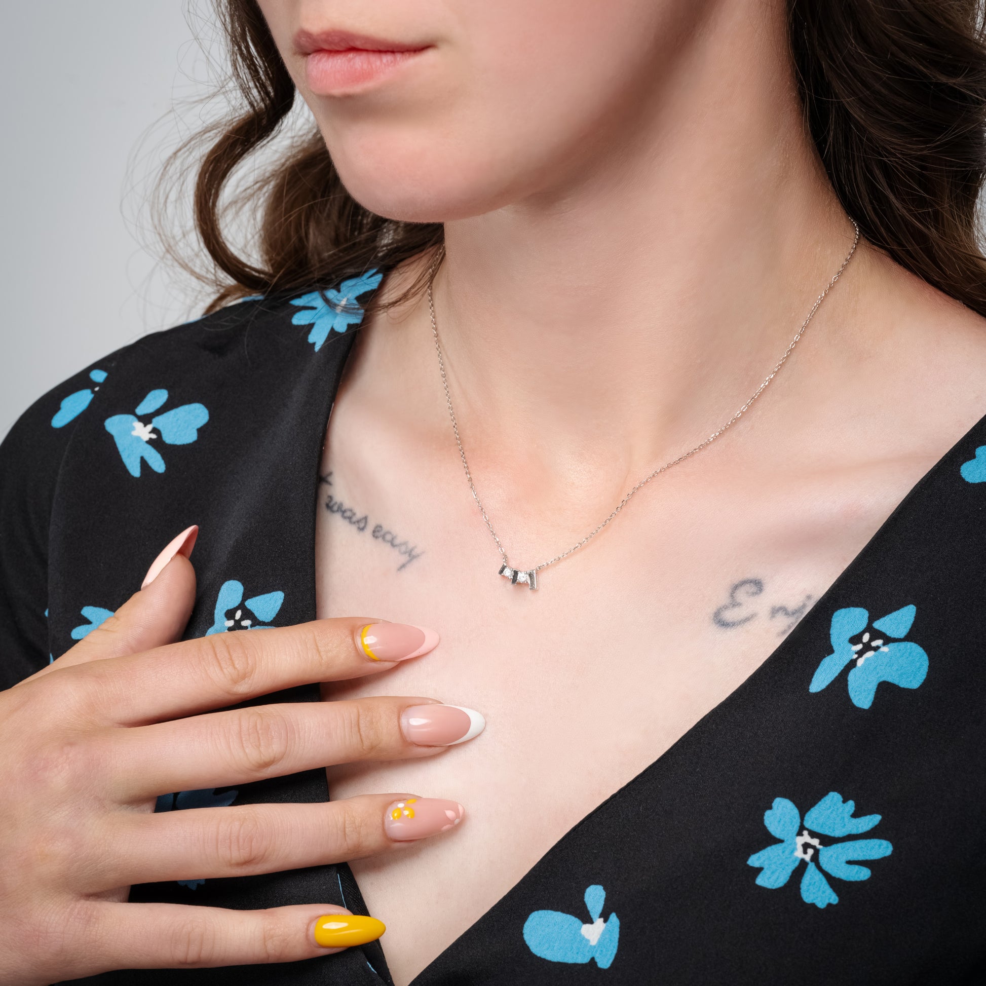 A model wearing Trilogy Silver Necklace on her neck