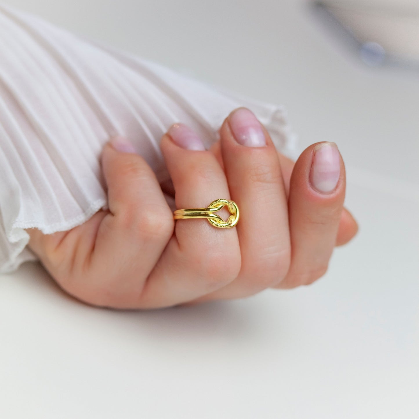 Knot Gold Ring on a woman's finger