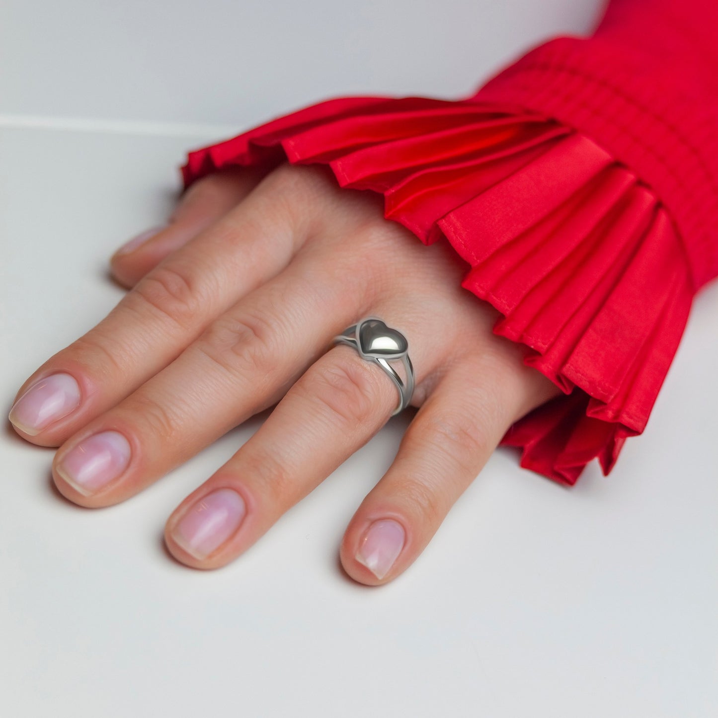 Love Heart Silver Ring on a woman's finger